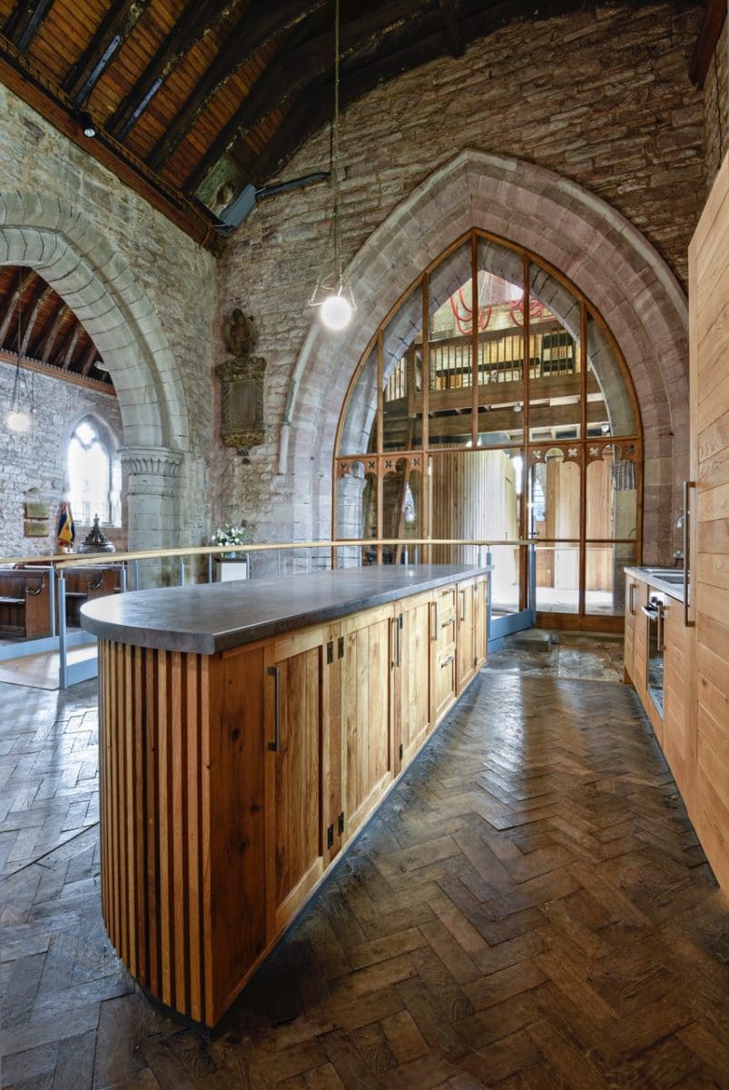 Kitchenette area in st Michaels and all angels, a timber kitchen island with a dark stone top, part of the church re-ordering.