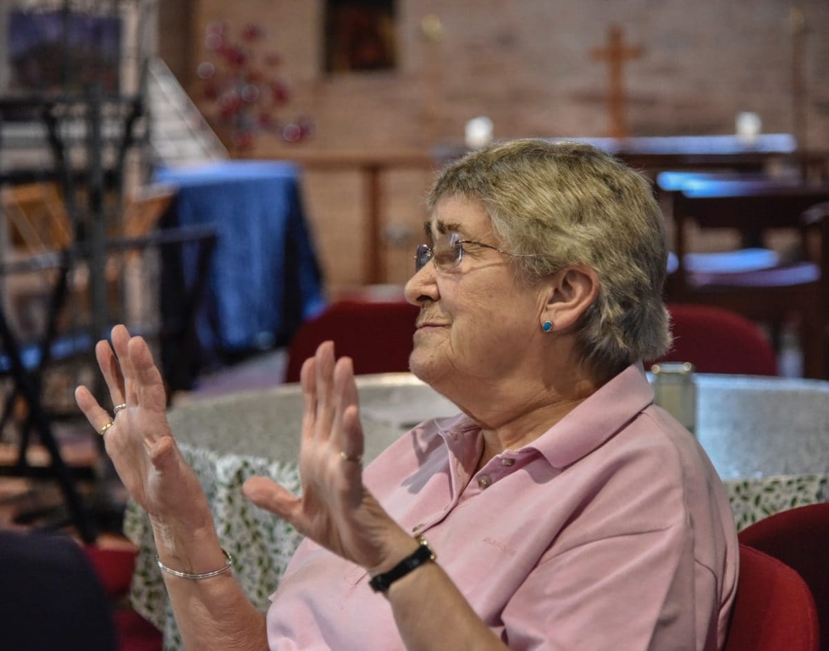 A women at the 'Take A Pew' cafe, st Michael and All Angels, church re-ordering.