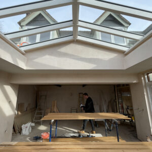 An apex roof light, part of a small orangery extension. Through the roof light, two dormer windows of the house can be seen. Communion Architects, Hereford, Herefordshire.