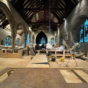 interior image of a church with a new floor being laid and new cabinets under construction - part of a church reordering scheme - communion architects Hereford.