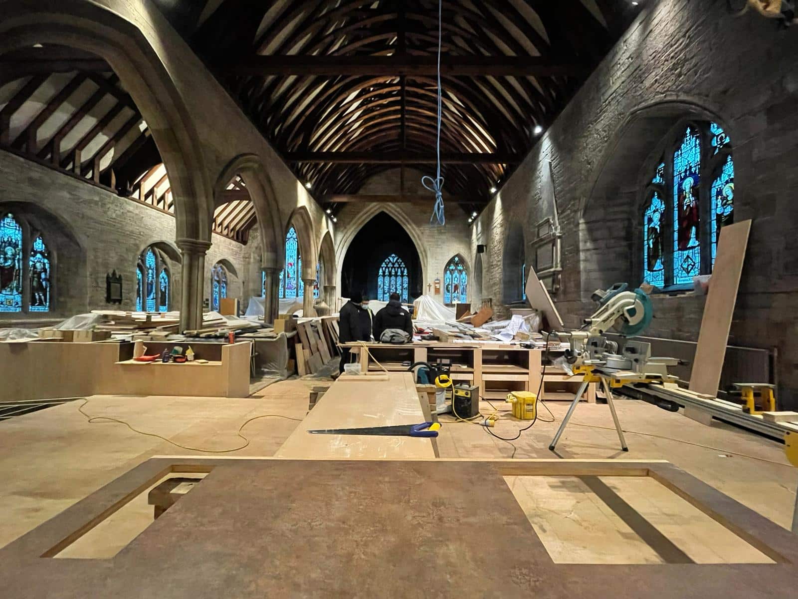 interior image of a church with a new floor being laid and new cabinets under construction - part of a church reordering scheme - communion architects Hereford.